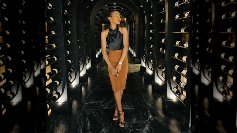 woman posing in wine cellar