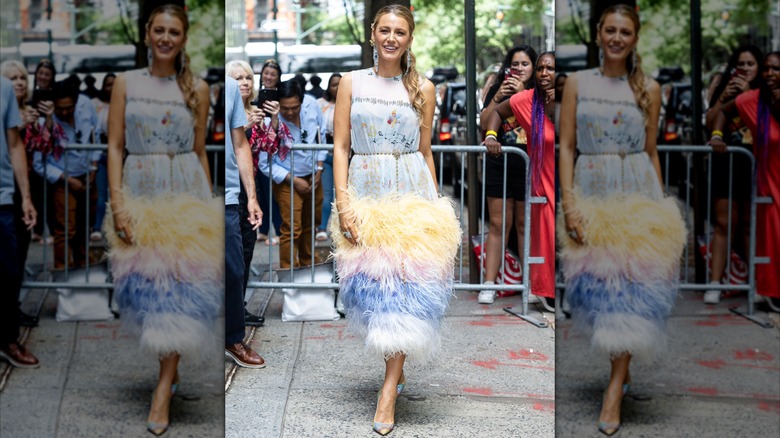 Blake Lively in a feather dress with a belt outside in 2024