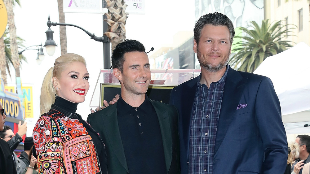 Gwen Stefani, Adam Levine, and Blake Shelton smiling 