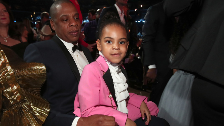 Blue Ivy Carter sitting on Jay-Z's lap at show