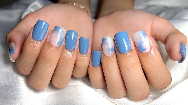 sky blue nails with clouds on some