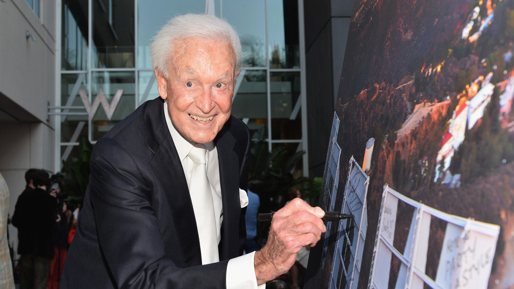 Bob Barker signing a poster