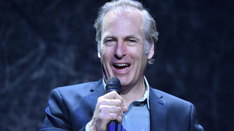 Bob Odenkirk laughing into microphone