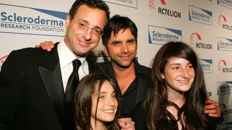 Bob Saget, Jennifer Saget, and Lara Saget posing with John Stamos