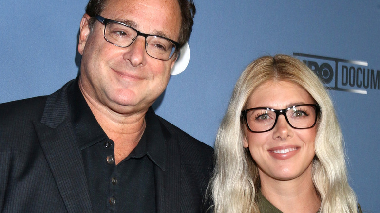 Bob Saget and Kelly Rizzo pose together on red carpet