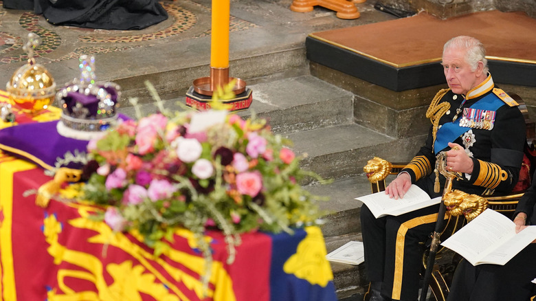 King Charles III watching Queen Elizabeth II's funeral