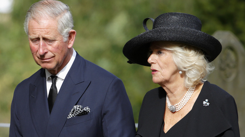 King Charles and Queen Camilla in black attire