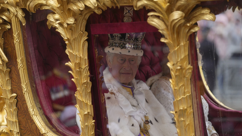 King Charles riding in stage coach at coronation