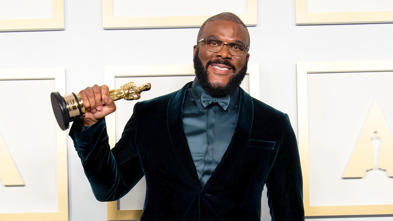 Tyler Perry proudly holds up his Oscar