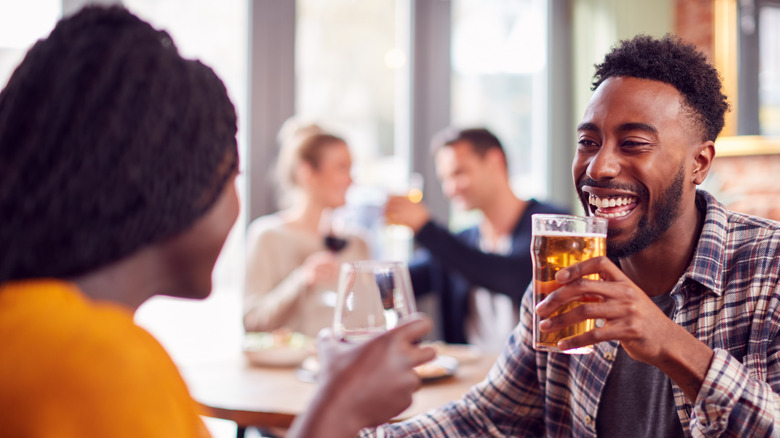 Couple having drinks and smiling on a date