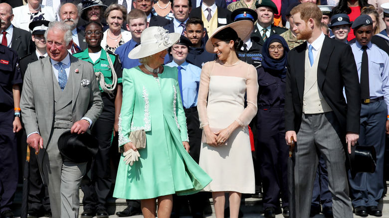 Charles, Camilla, Meghan Markle, and Harry stand together at a public outing 