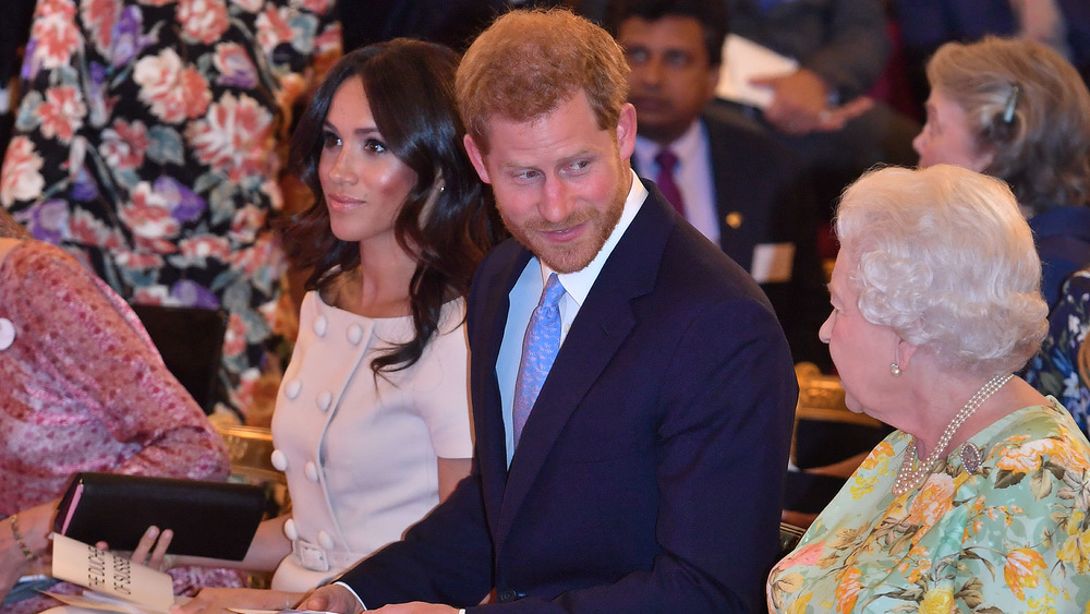 Harry looking at Queen Elizabeth