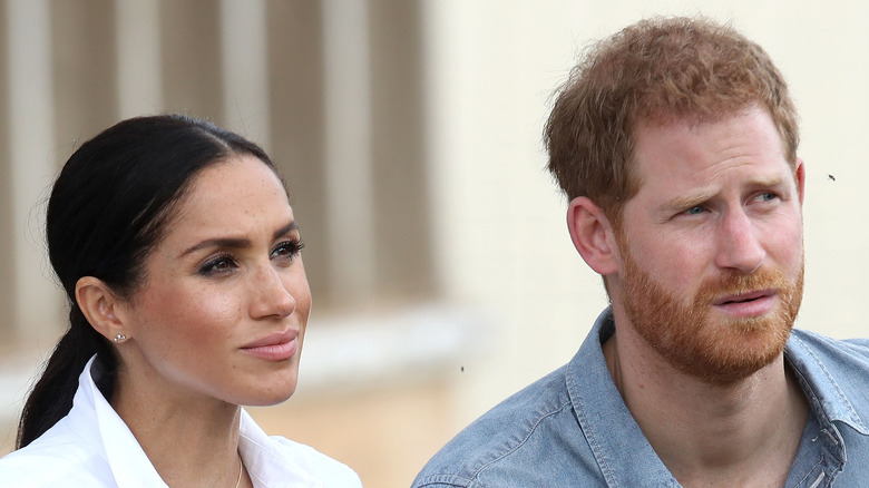 Meghan Markle and Prince Harry listening