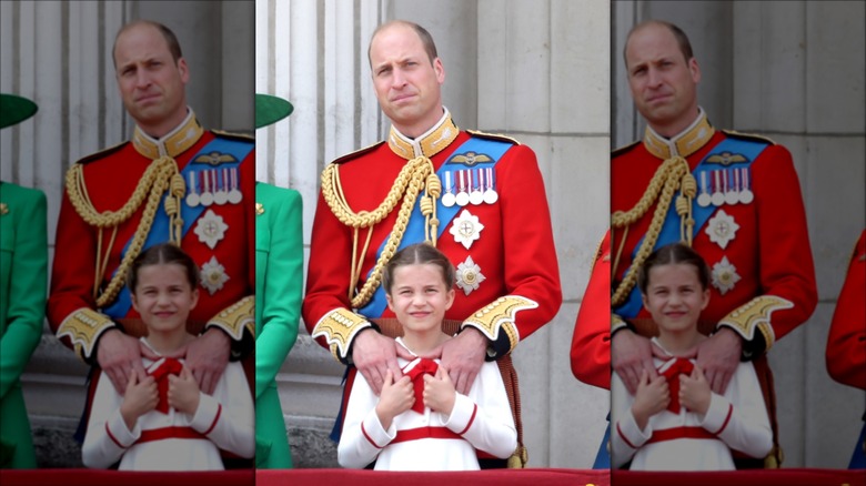 Prince William with hands on Princess Charlotte's shoulders