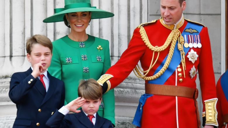 Prince George and Prince Louis salute crowd with royal family