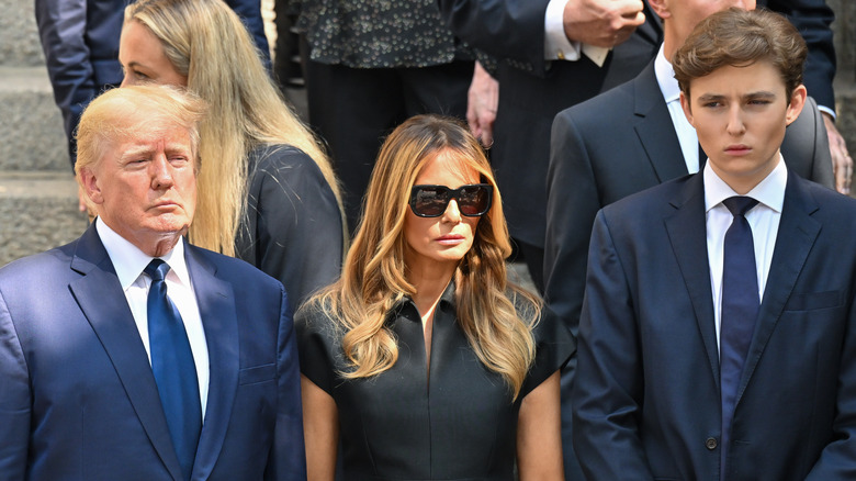 Donald Trump, Melania Trump, and Barron Trump scowling