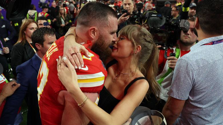 Swift and Kelce embracing at the Super Bowl 