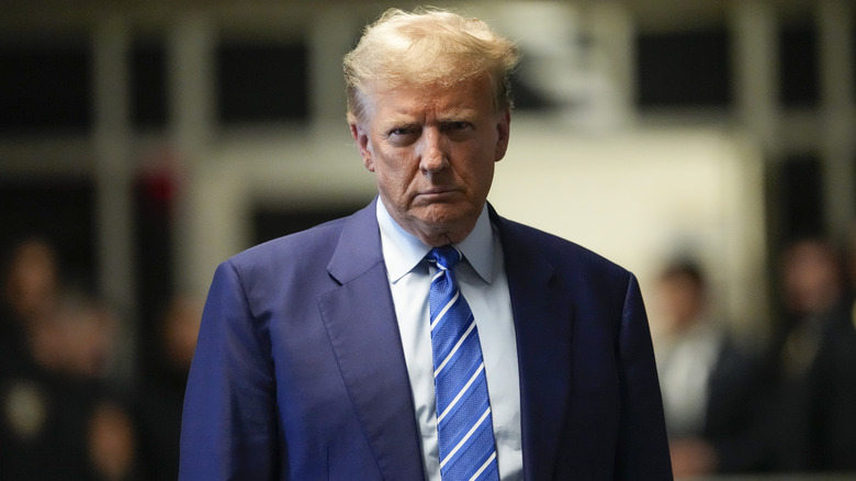 Donald Trump frowning at camera blue white striped tie