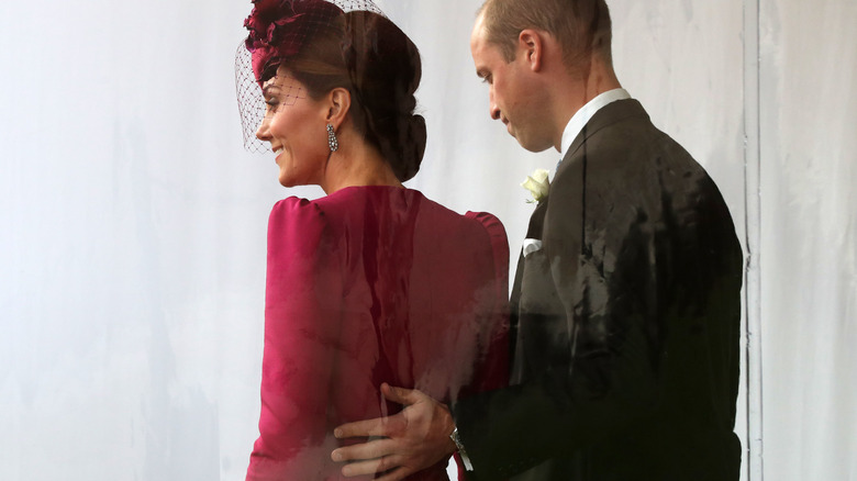 William hand on Kate's back