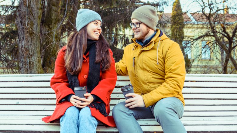 man and woman flirting at park