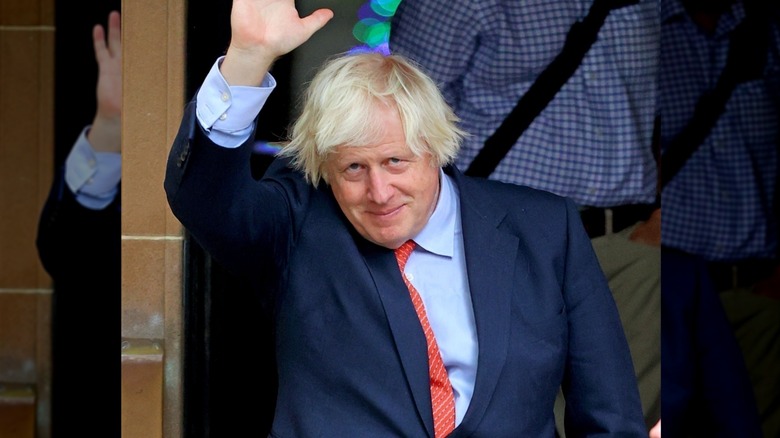 Boris Johnson waving with hair standing disheveled