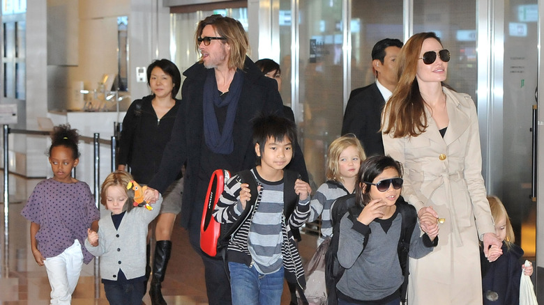 Brad Pitt and Angelina Jolie walking with their six kids