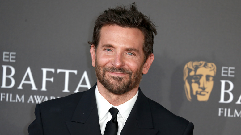 Bradley Cooper smiling in a dark suit