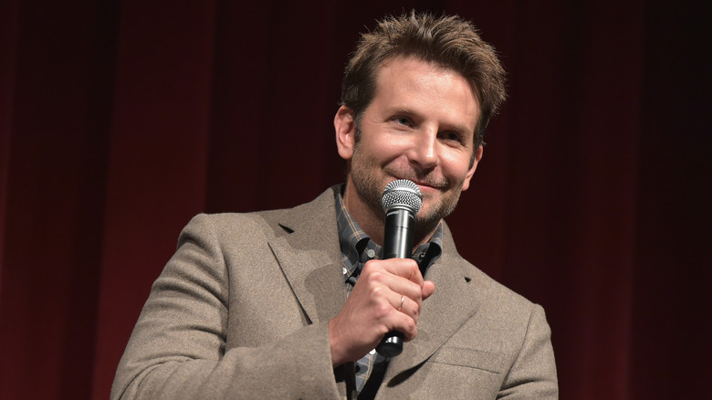 Bradley Cooper holding a microphone