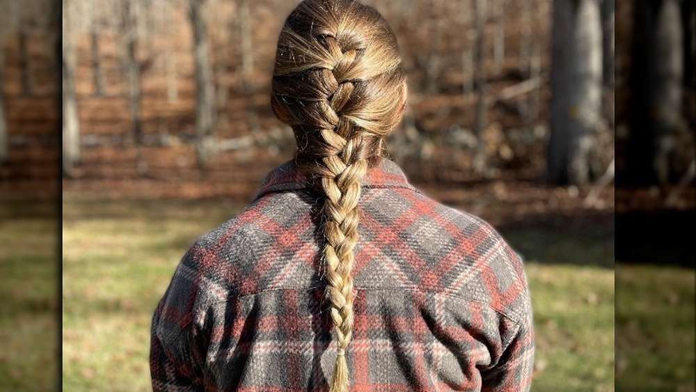 Girl with French braid in plaid shirt