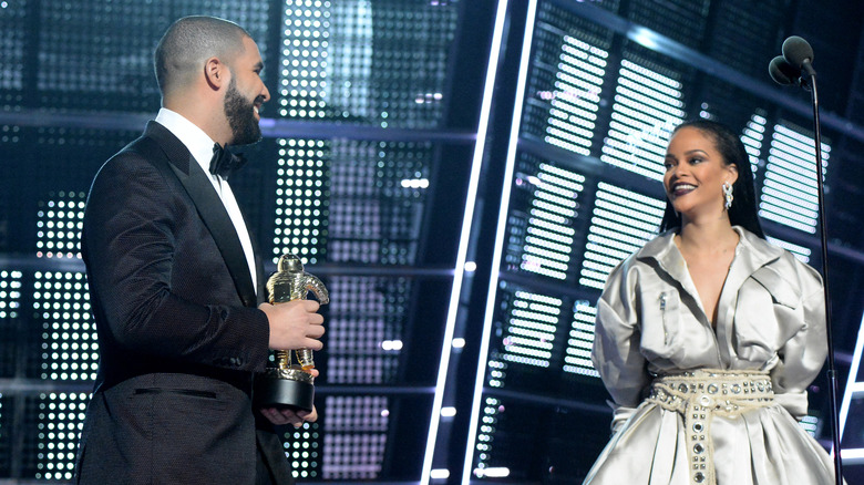 Drake presenting award to Rihanna