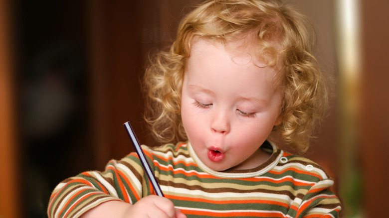 cute little girl excitedly writing