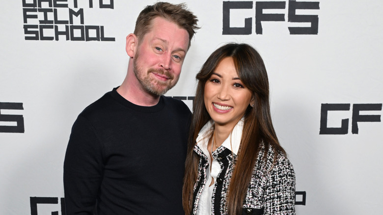 Macaulay Culkin arm around Brenda Song in casual wear