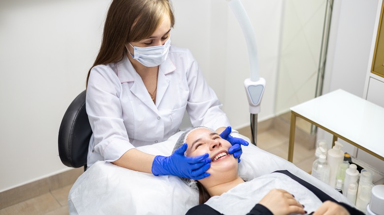 Woman being treated by a dermatologist