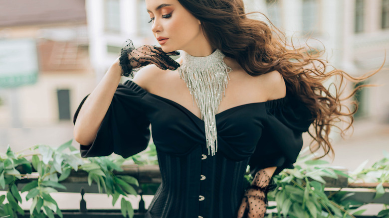 Woman wearing black corset dress