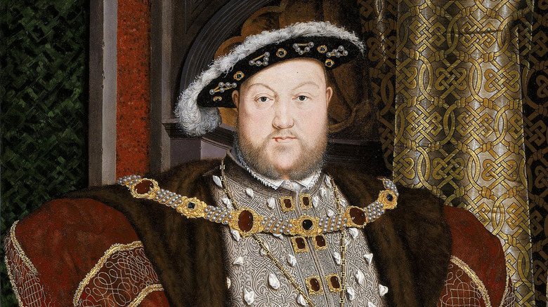 A painted portrait of Henry VIII in a robe and feathered cap 