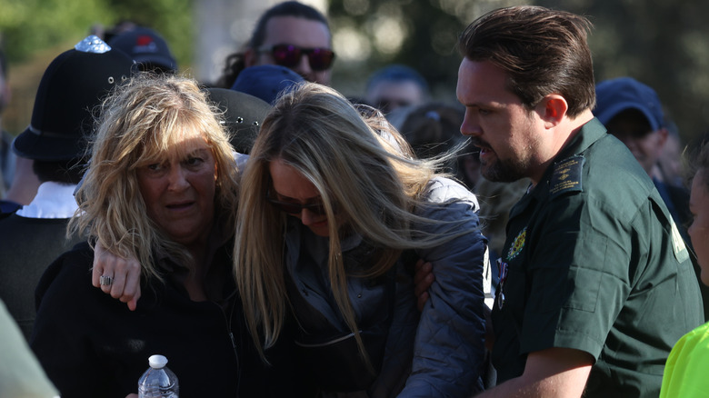 A mourner being helped by the London Ambulance Service