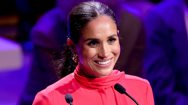 Meghan Markle standing at microphone