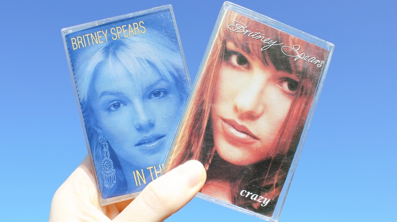 Hand holds up two Britney Spears cassette tapes