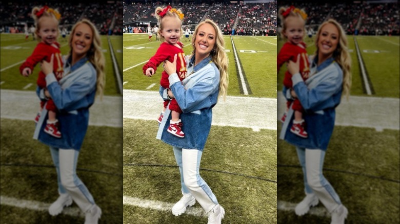 Brittany Mahomes holding daughter on sidelines