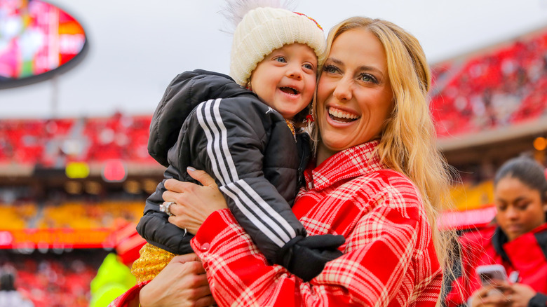 Brittany Mahomes holding daughter at game