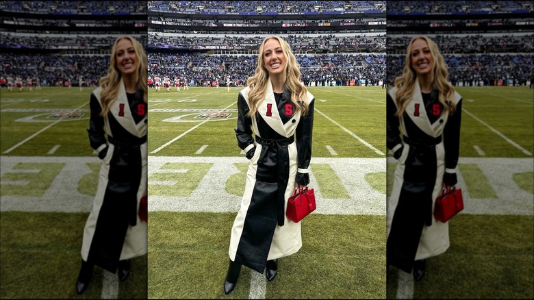 Brittany Mahomes smiles on a football field 