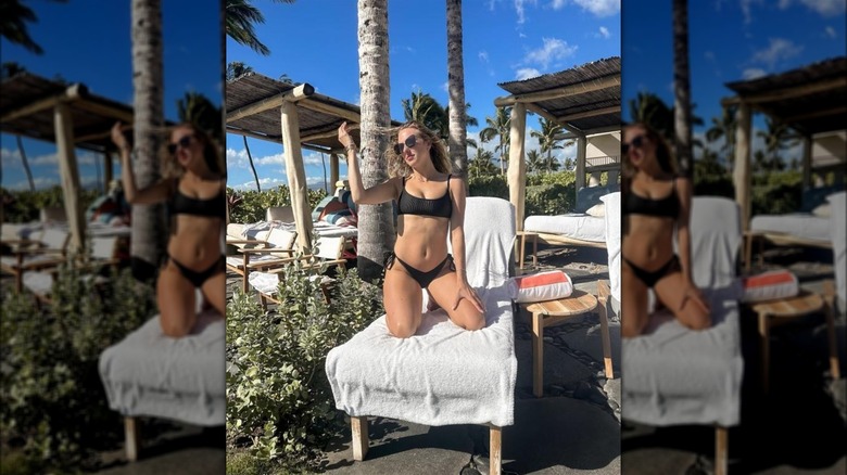 Brittany Mahomes poses in black bikini on a beach chair