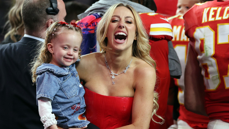 Brittany Mahomes holding Sterling Skye Mahomes and laughing