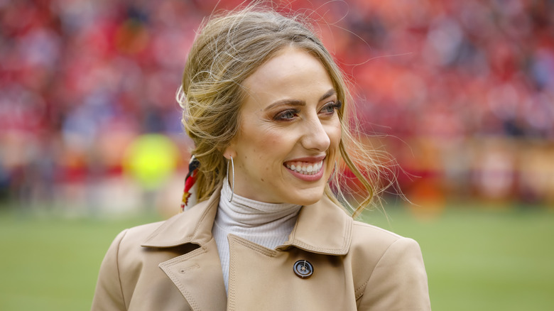 Brittany Mahomes smiles on a field