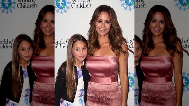 Brooke Burke posing with young Heaven Rain Charvet