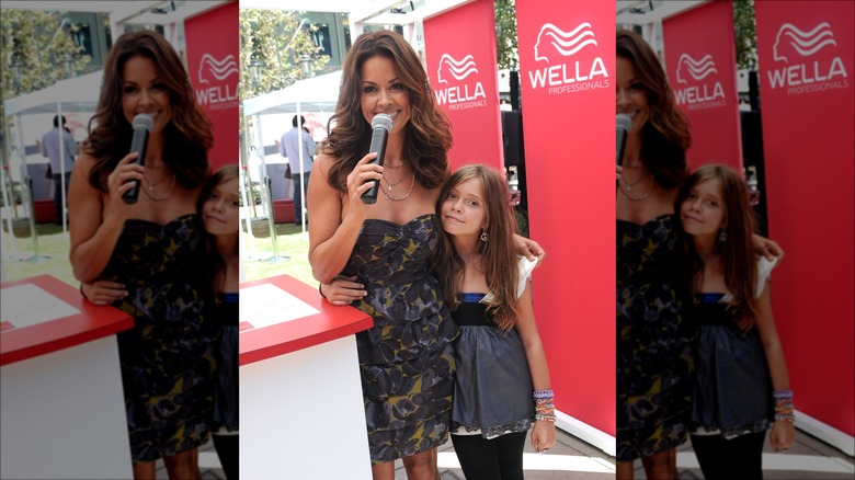 Brooke Burke standing with daughter Neriah Fisher