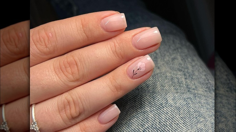 Simple nails with flower on ring finger