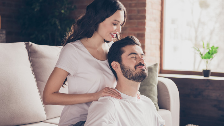 Woman massaging her boyfriend