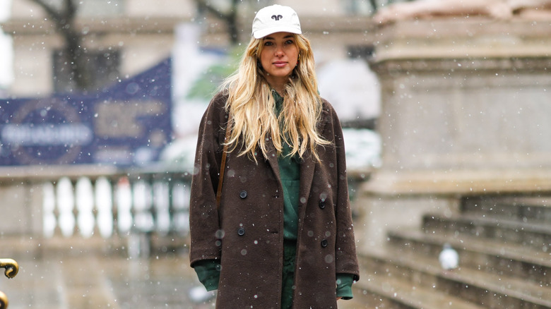 woman wearing college sweatshirt cap