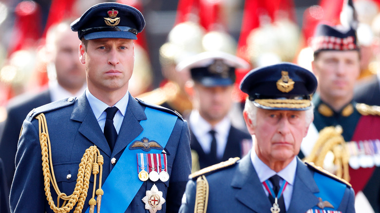 Prince William and King Charles marching in a procession